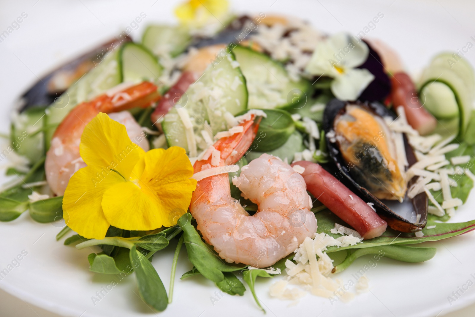 Photo of Plate of delicious salad with seafood, closeup view