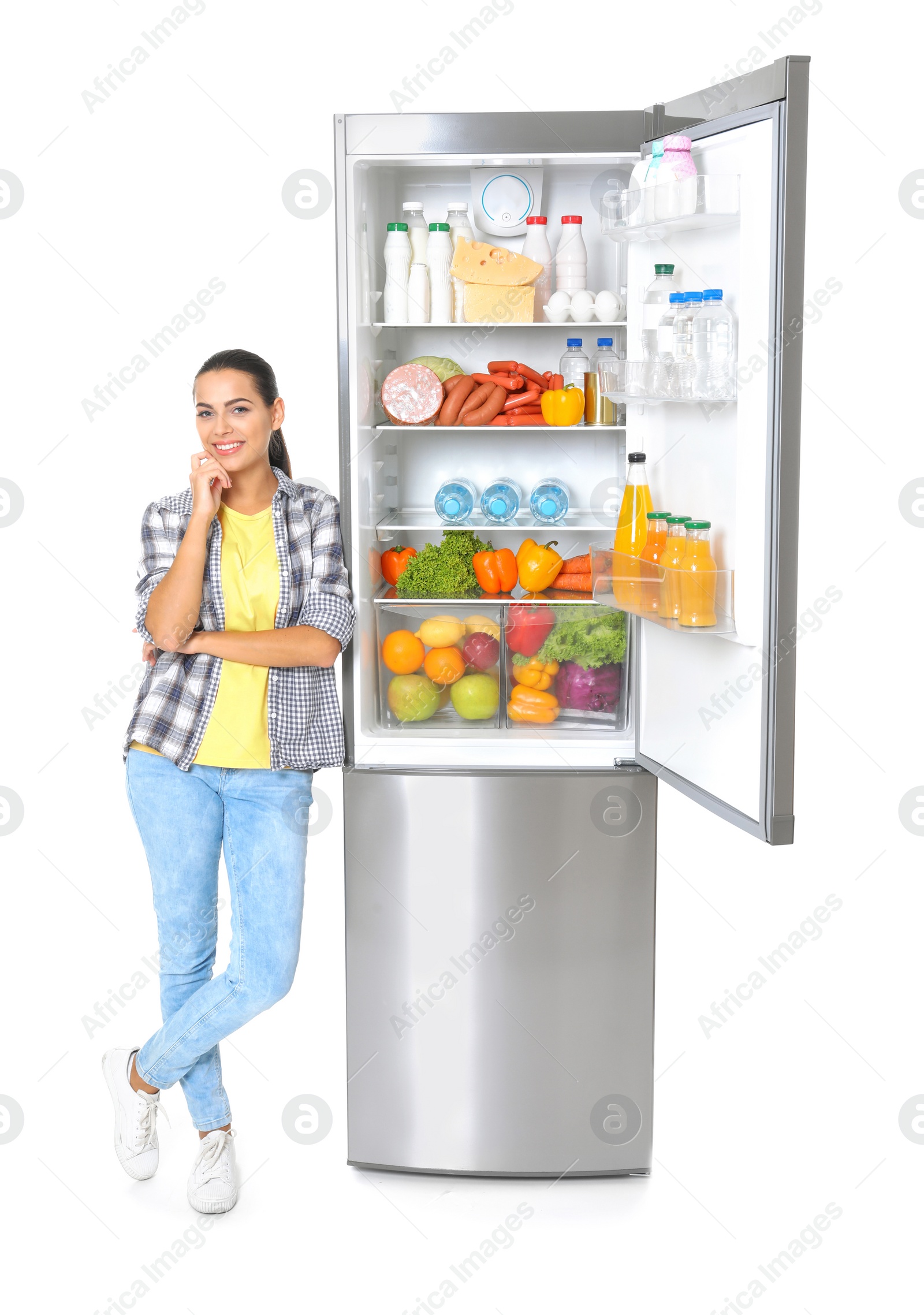 Photo of Young woman near open refrigerator on white background