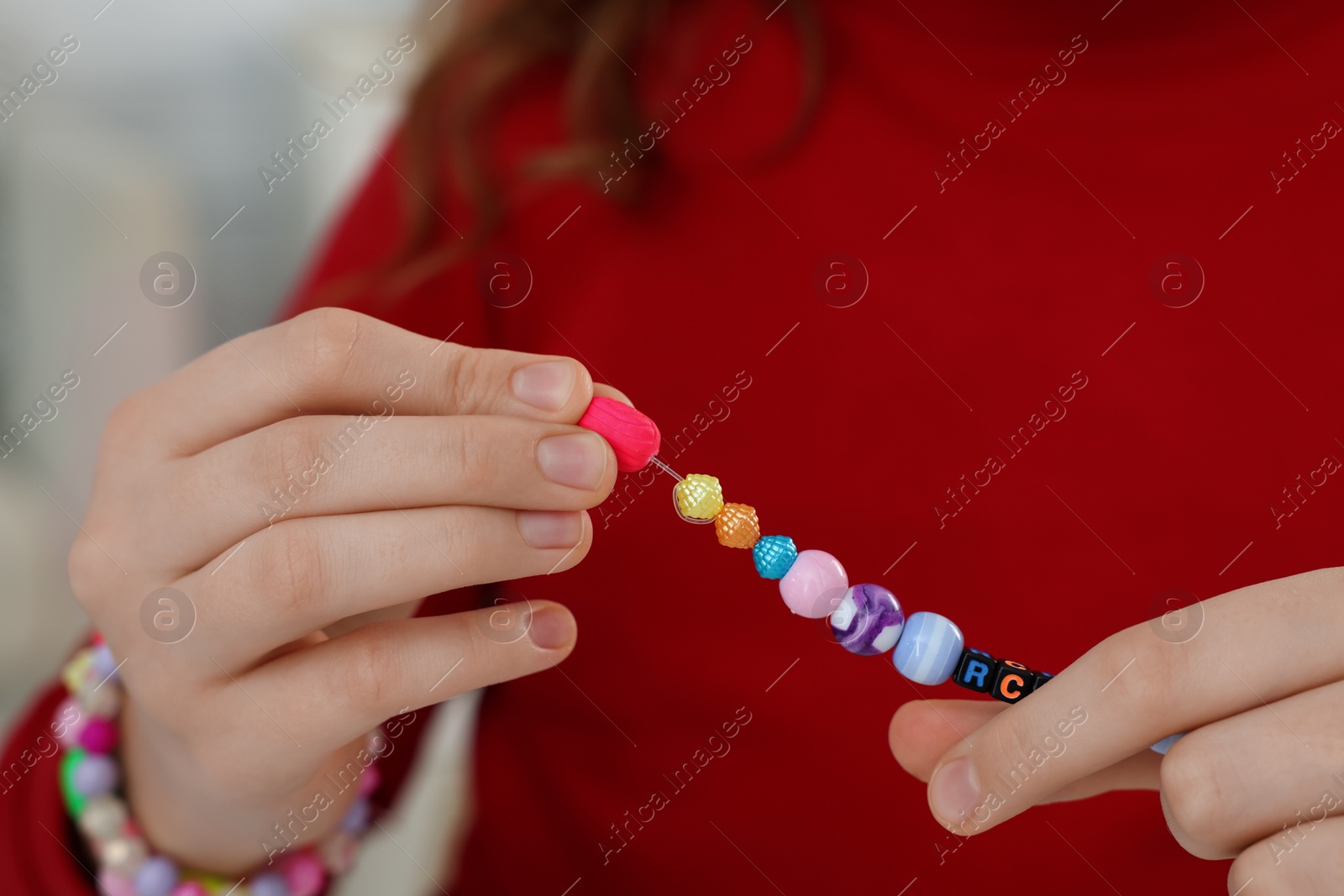 Photo of Girl with bright handmade beaded jewelry, closeup