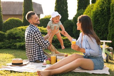 Photo of Happy family having picnic in garden on sunny day