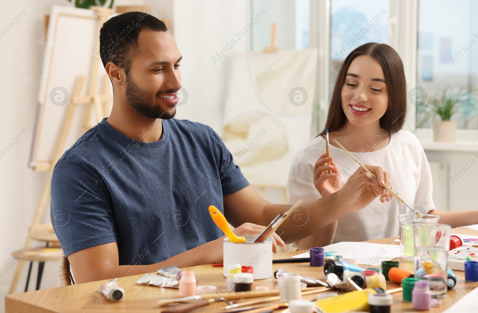 Photo of Students attending painting class in studio. Creative hobby