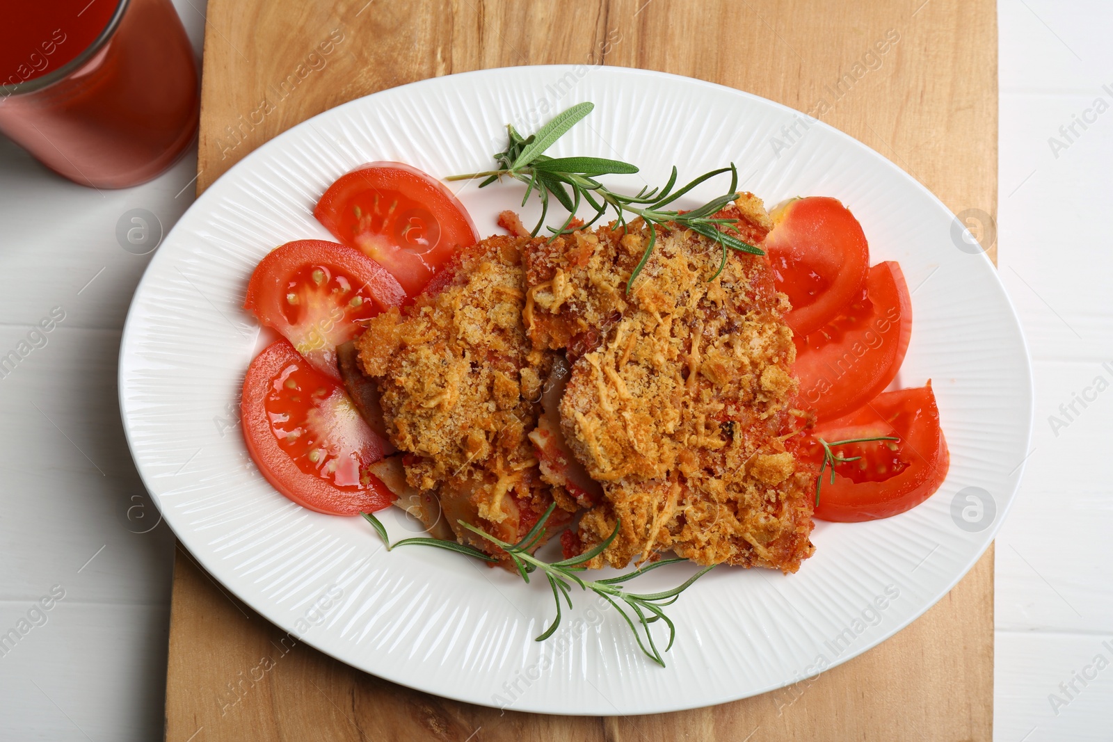 Photo of Tasty fried parsnips with fresh tomatoes and rosemary on white wooden table, top view