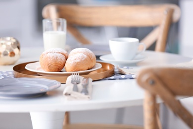 Tasty breakfast with fresh croissants on table