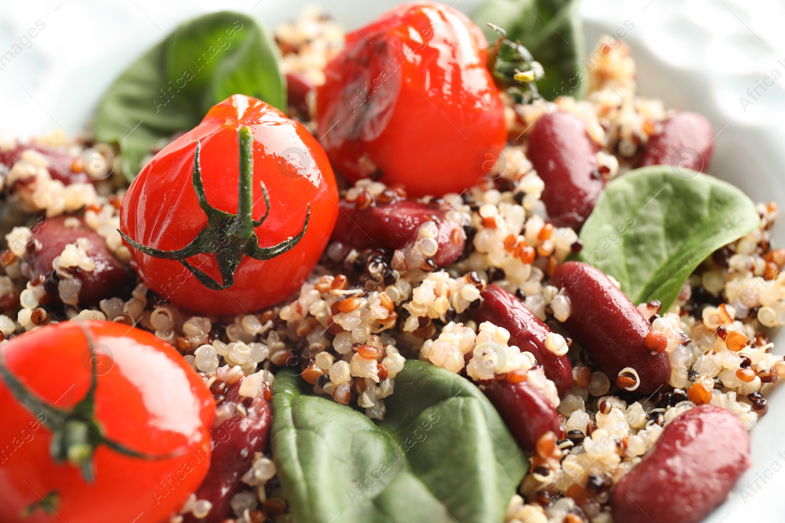 Photo of Healthy fresh quinoa salad with vegetables in plate, closeup