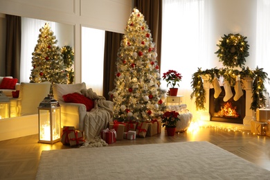 Stylish room interior with fireplace and beautiful Christmas tree