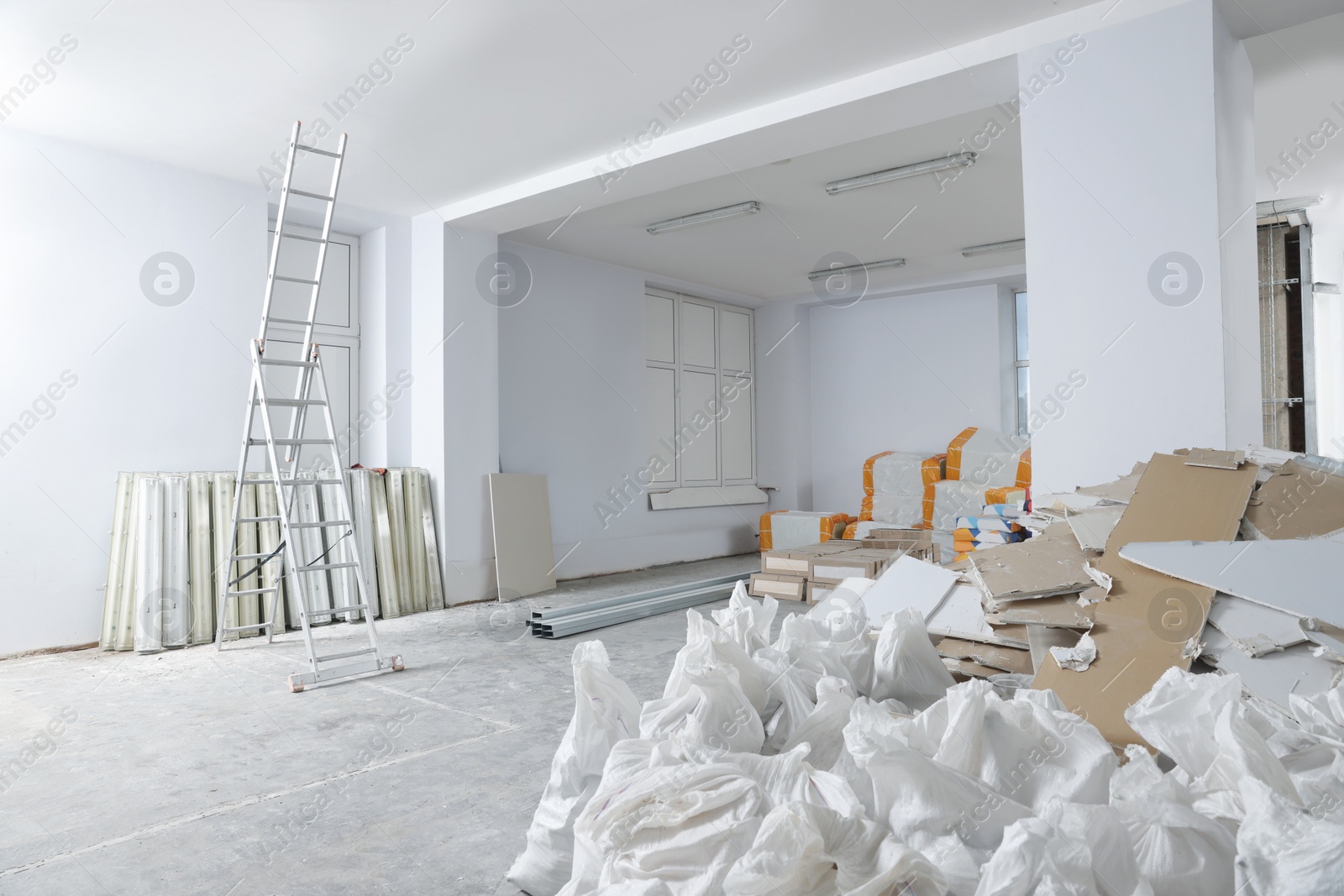 Photo of Used and new building materials in room prepared for renovation