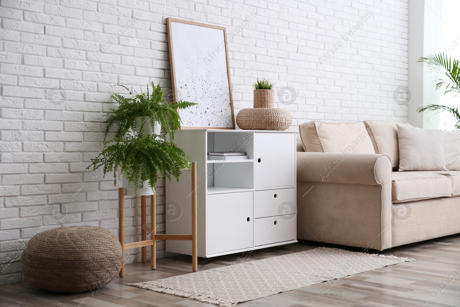 Photo of Modern room interior with stylish white cabinet