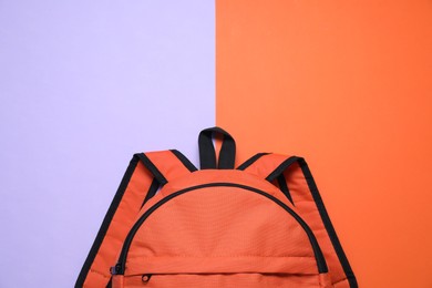 Photo of Stylish orange backpack on color background, top view. Space for text