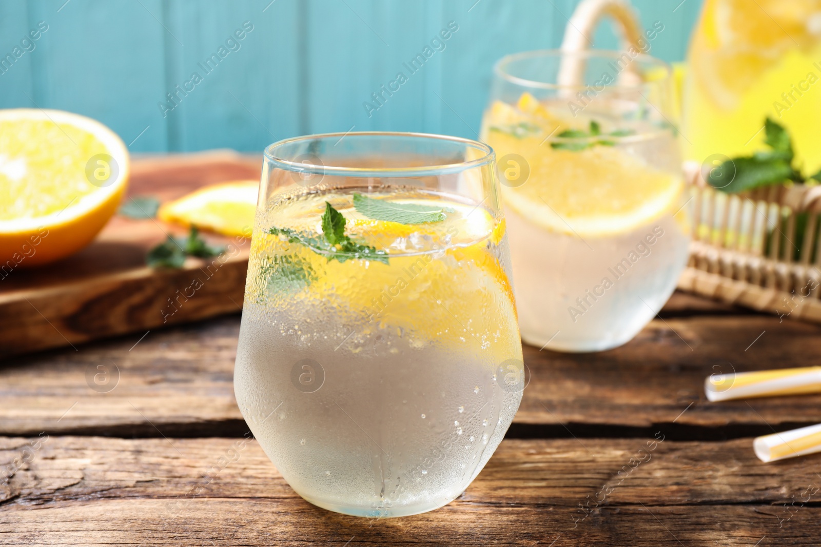 Photo of Delicious refreshing citrus drink on wooden table