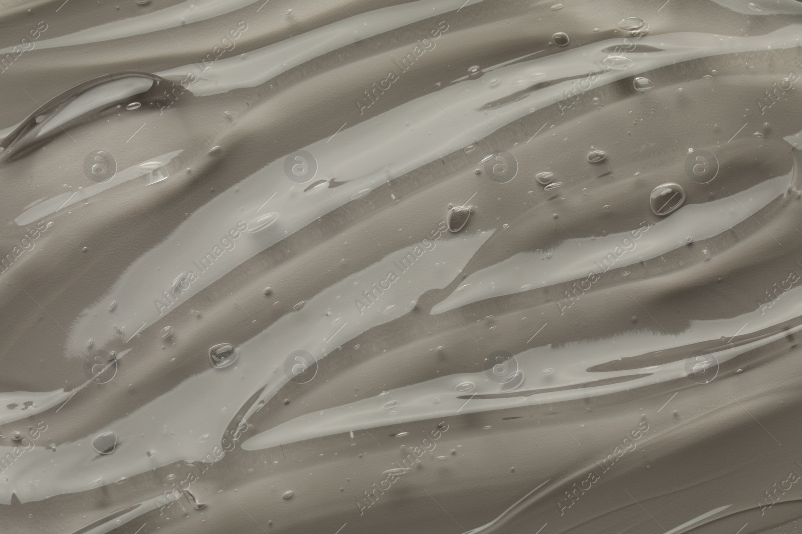 Photo of Clear cosmetic gel on grey background, top view