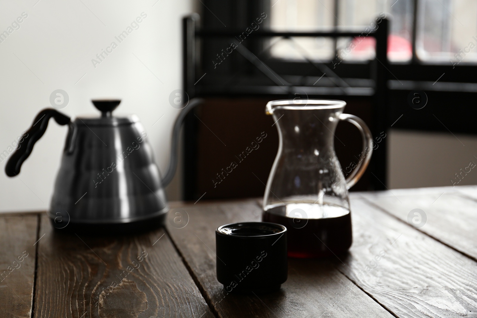 Photo of Aromatic coffee on wooden table in cafe