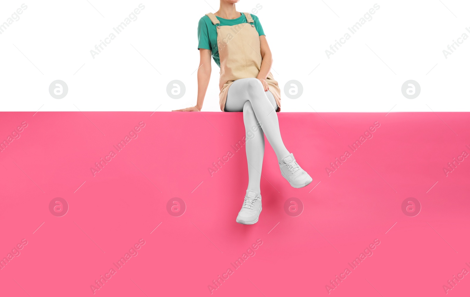 Photo of Woman wearing white tights and stylish shoes sitting on color background, closeup