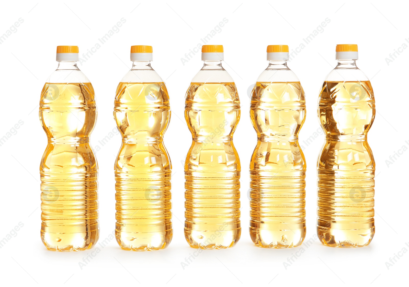 Photo of Row of plastic bottles with oil on white background