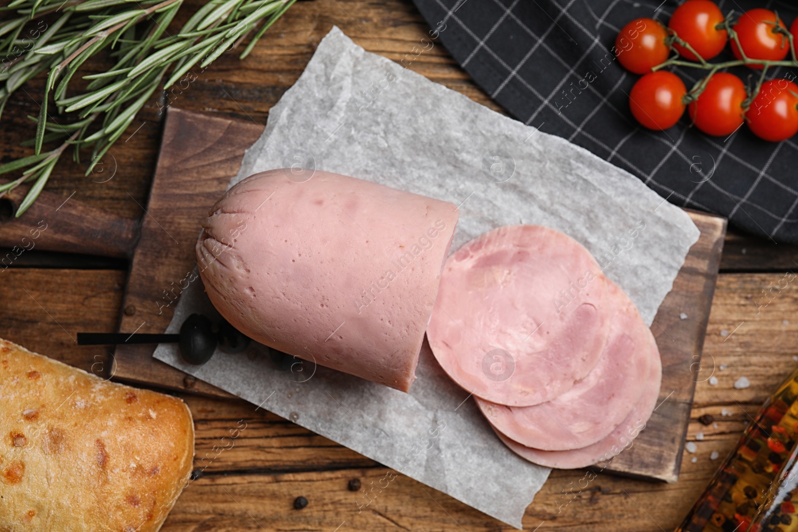 Photo of Flat lay composition with tasty ham on wooden table