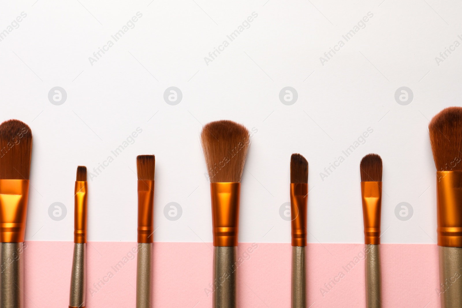 Photo of Set of makeup brushes on color background, flat lay. Space for text