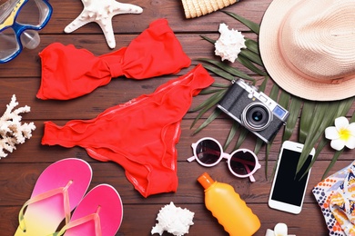 Flat lay composition with beach objects on wooden background