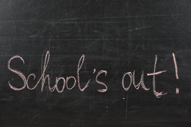 Text School's Out written on black chalkboard. Summer holidays