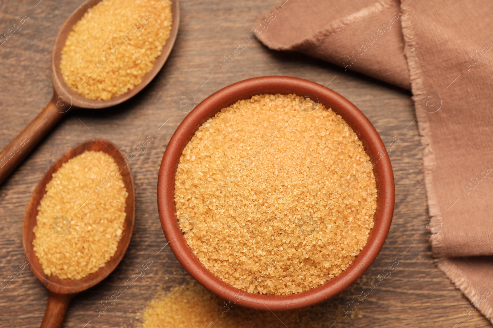 Photo of Brown sugar on wooden table, flat lay