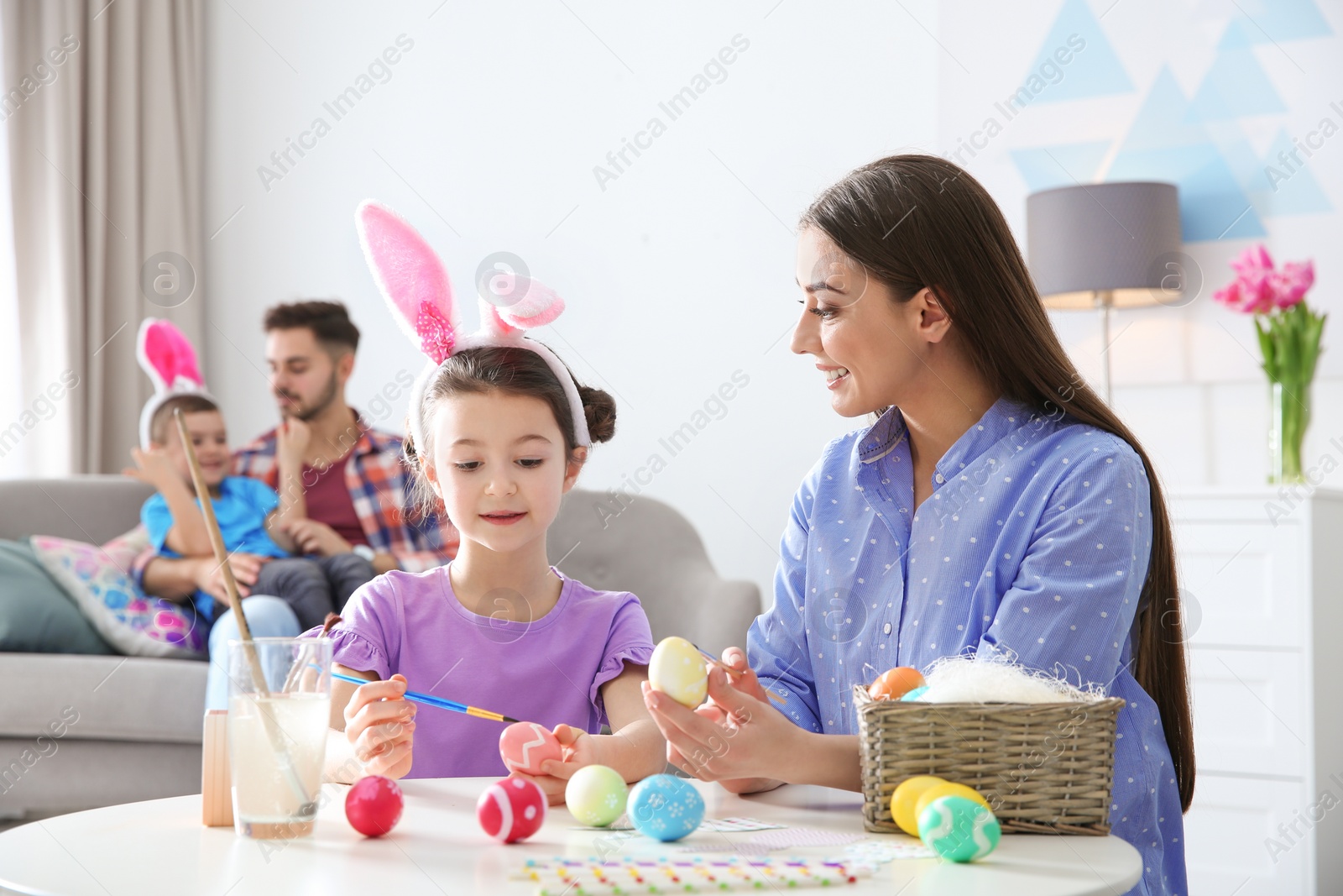 Photo of Happy family preparing for Easter holiday at home