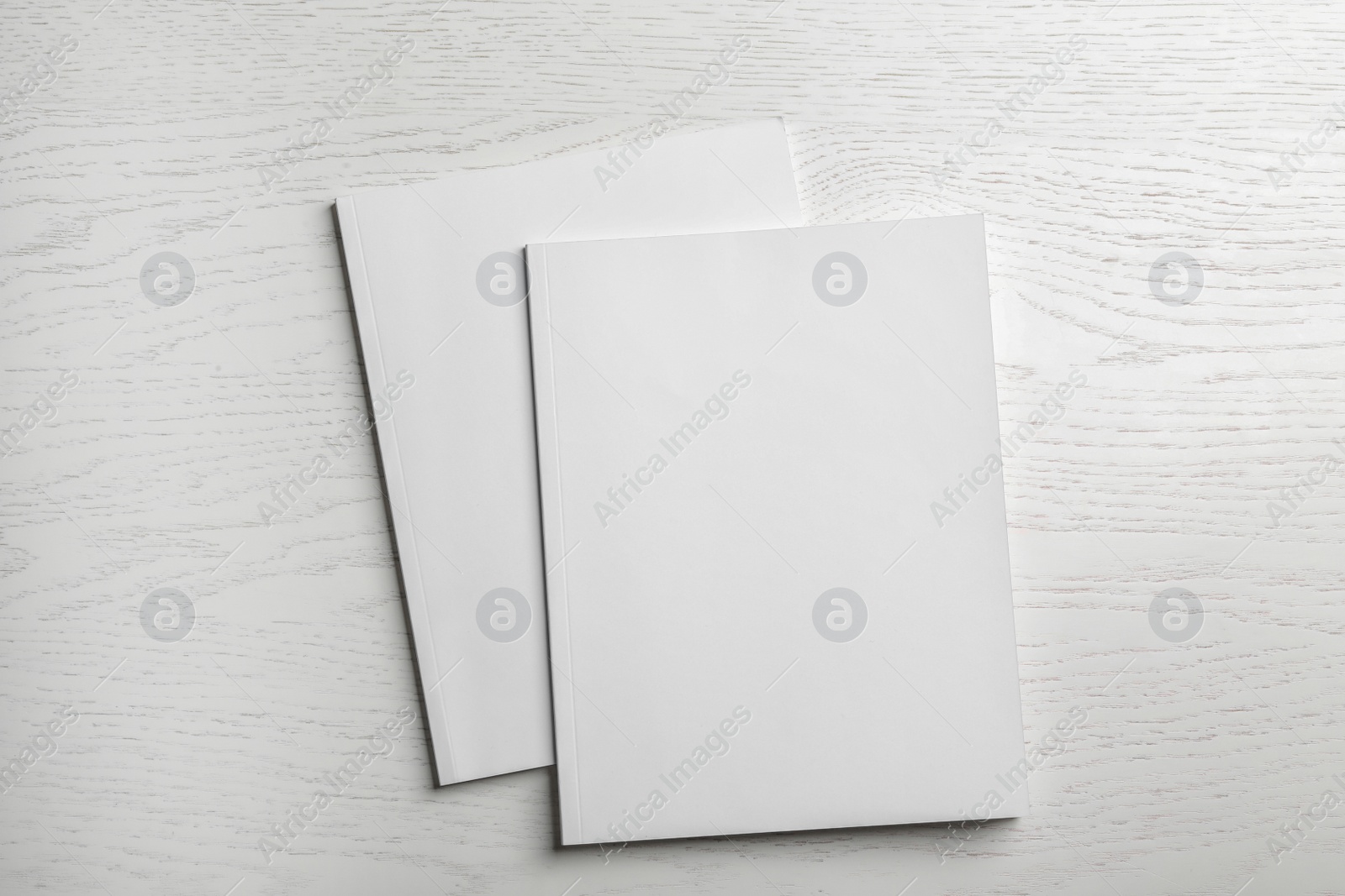 Photo of Brochures with blank cover on wooden background, top view. Mock up for design