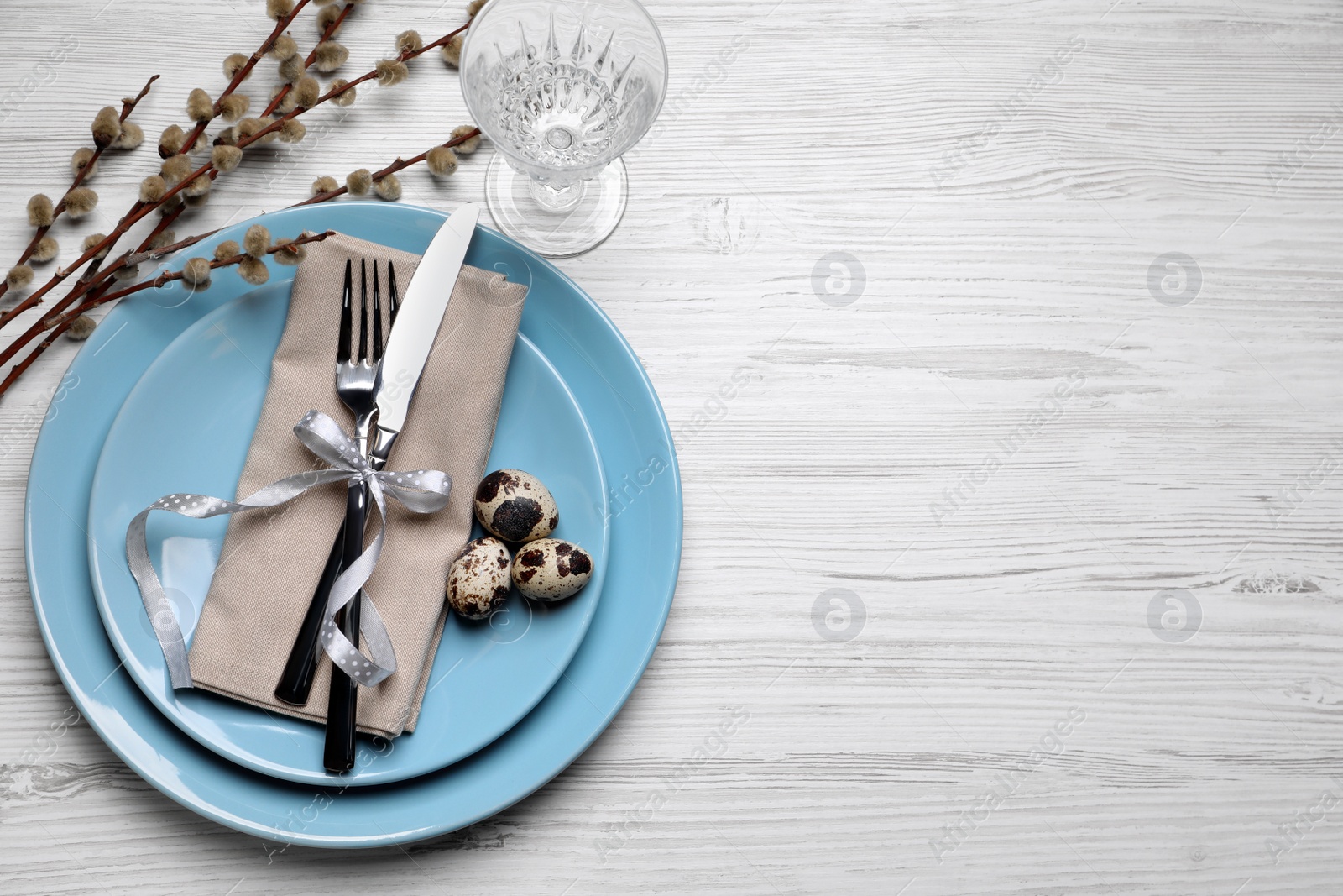 Photo of Festive Easter table setting with eggs on white wooden background, flat lay. Space for text