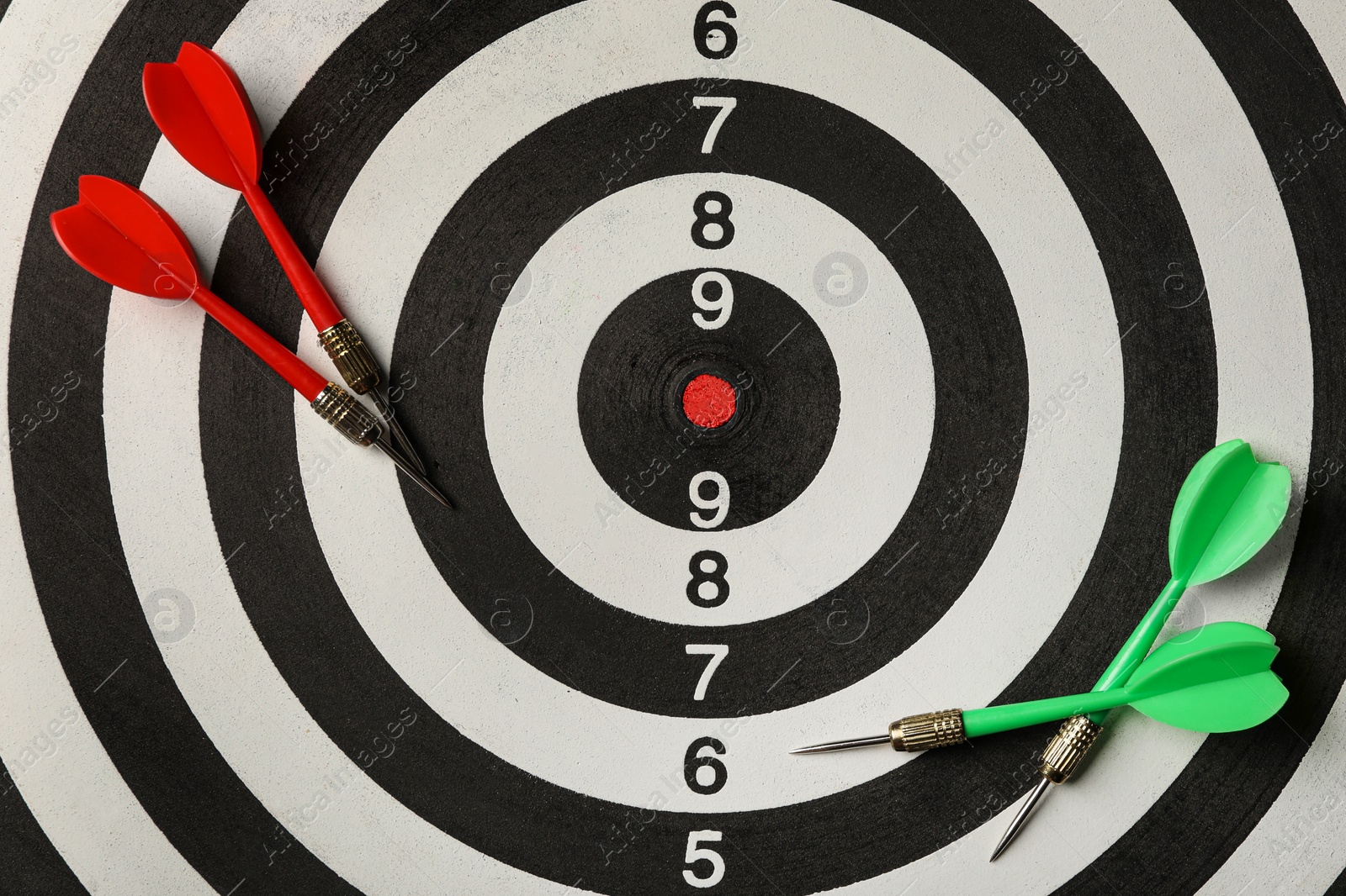 Photo of Red and green arrows on dart board, top view