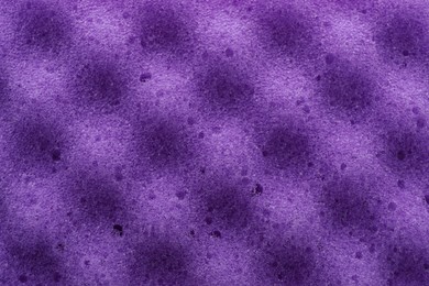 Photo of Purple cleaning sponge as background, top view