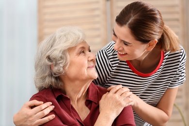 Elderly woman with female caregiver at home