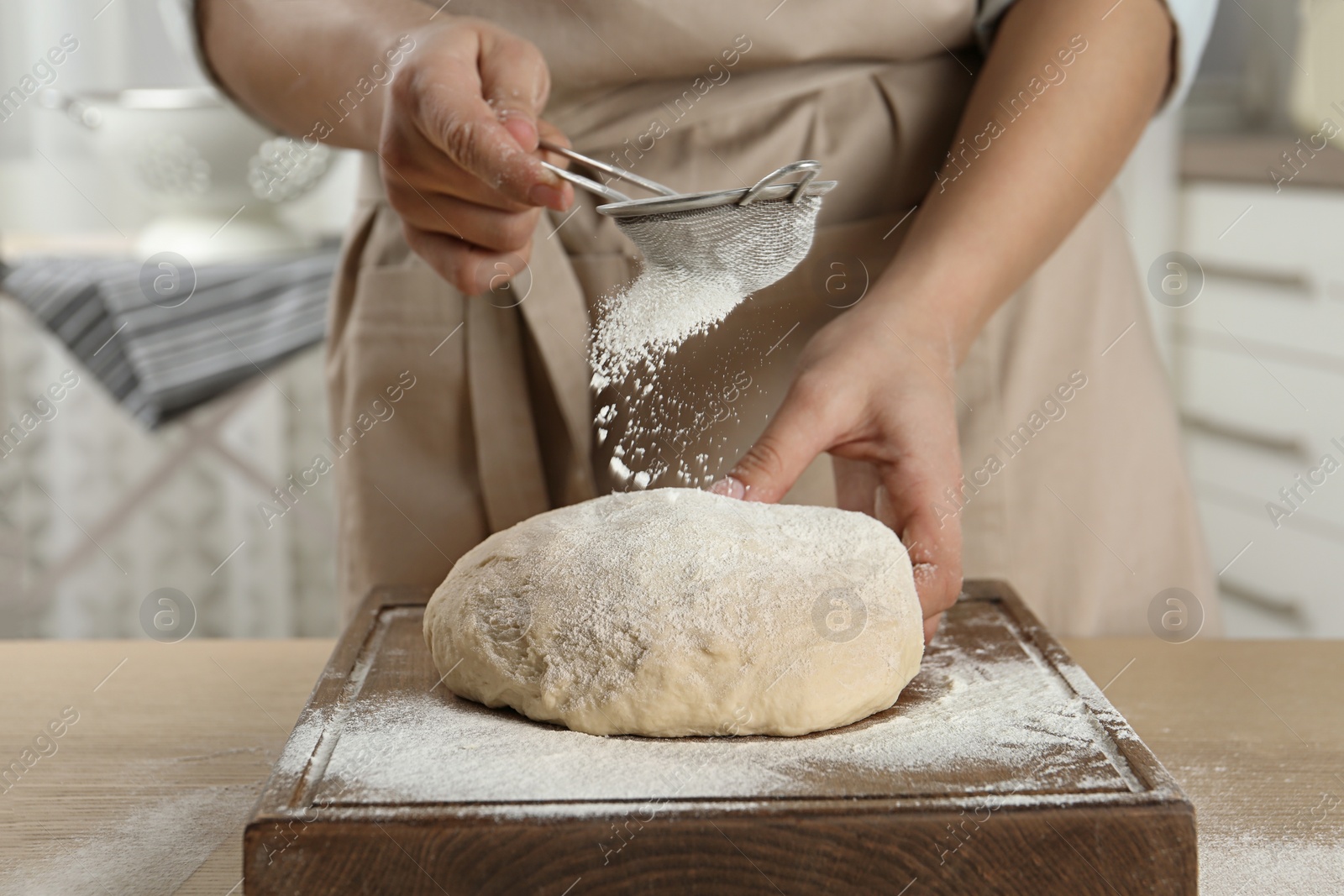 Photo of Female baker preparing bread dough at table, closeup