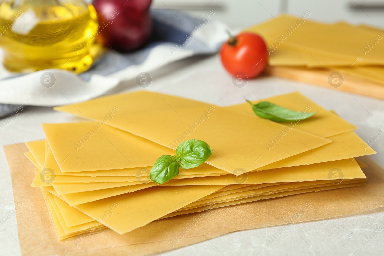 Photo of Composition with uncooked lasagna sheets on marble table, closeup