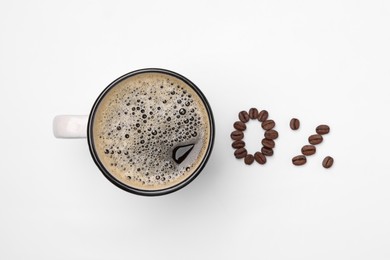 Photo of Cup of coffee and 0 percent made with beans on white background, top view. Decaffeinated drink