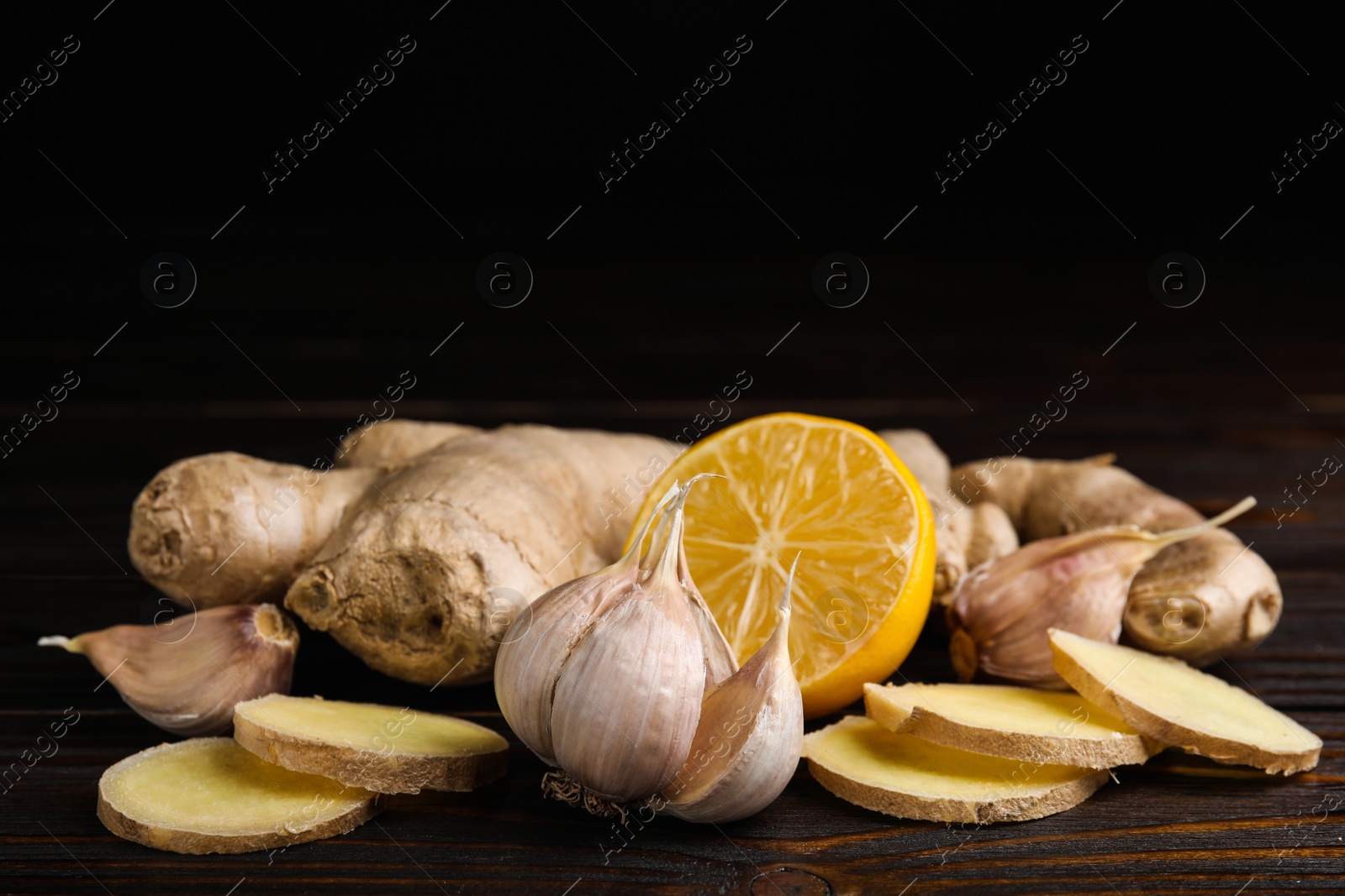 Photo of Fresh garlic and other natural cold remedies on wooden table. Space for text