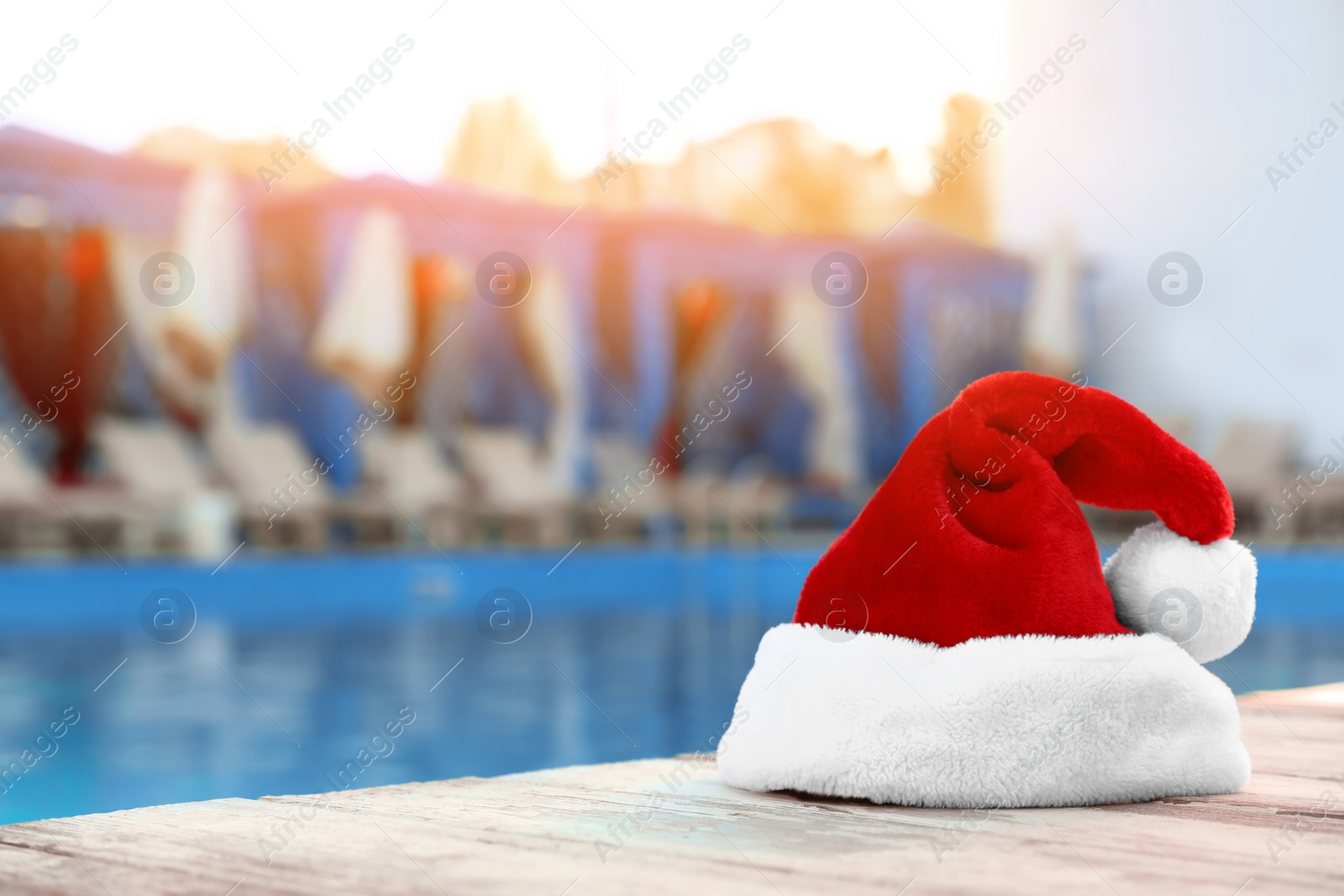 Photo of Authentic Santa Claus hat near pool at resort