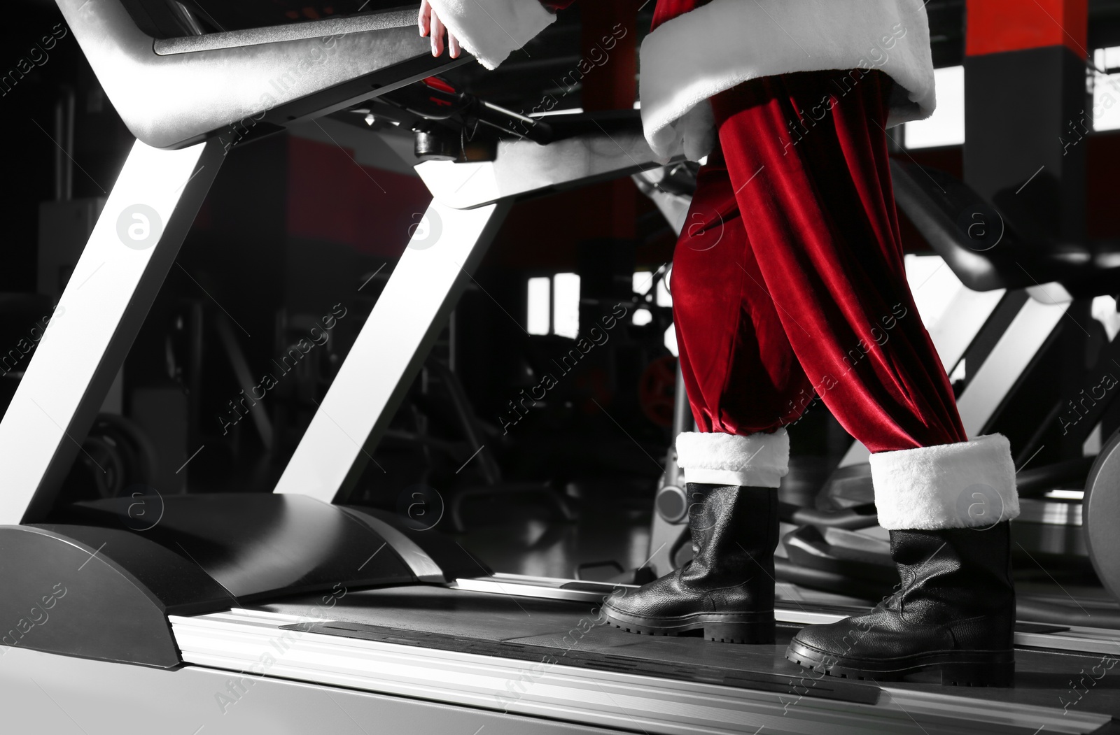 Photo of Authentic Santa Claus training on treadmill in modern gym, closeup