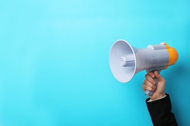 Photo of Man holding megaphone on color background