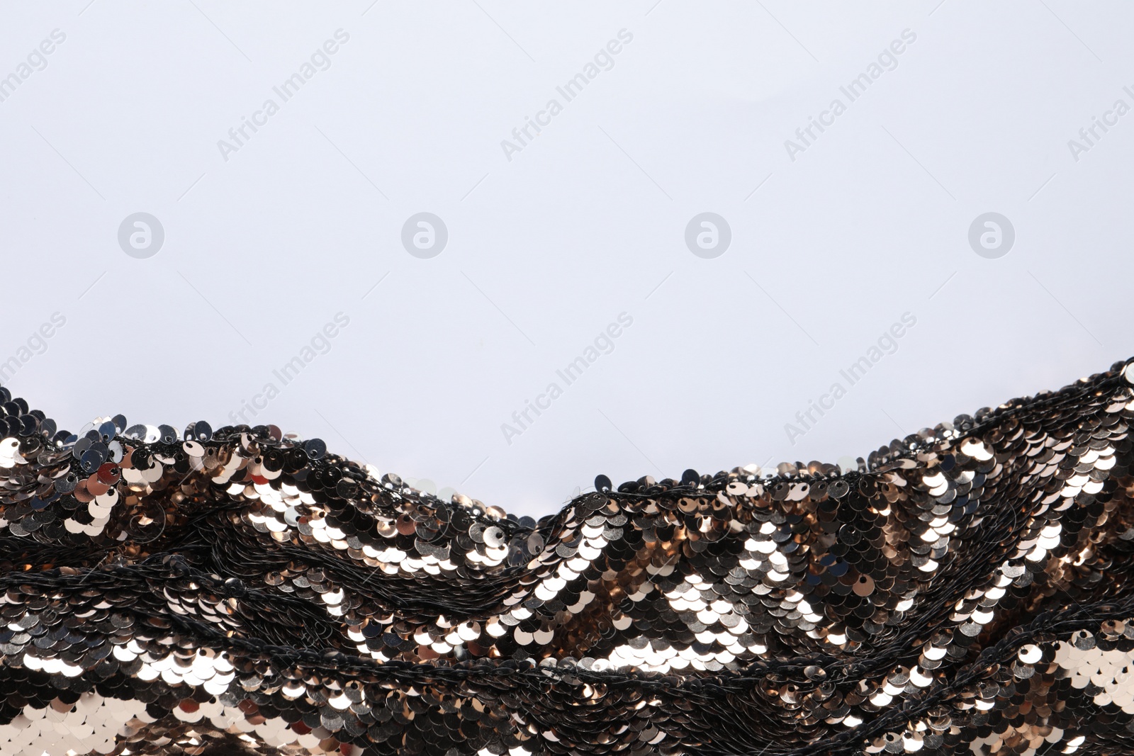 Photo of Beautiful golden sequin fabric on white background, top view. Space for text