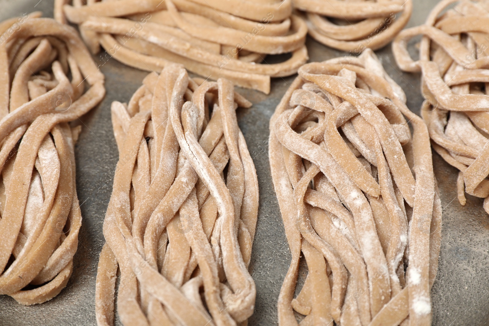 Photo of Uncooked homemade soba on tray, closeup view