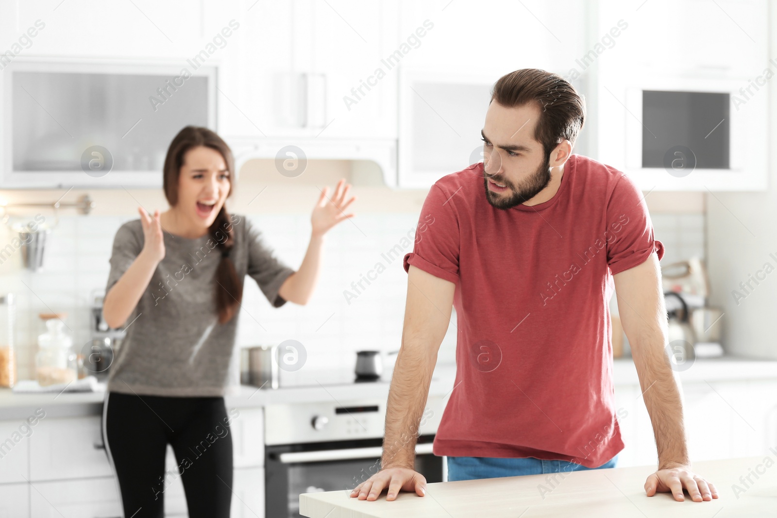 Photo of Young couple having argument in kitchen