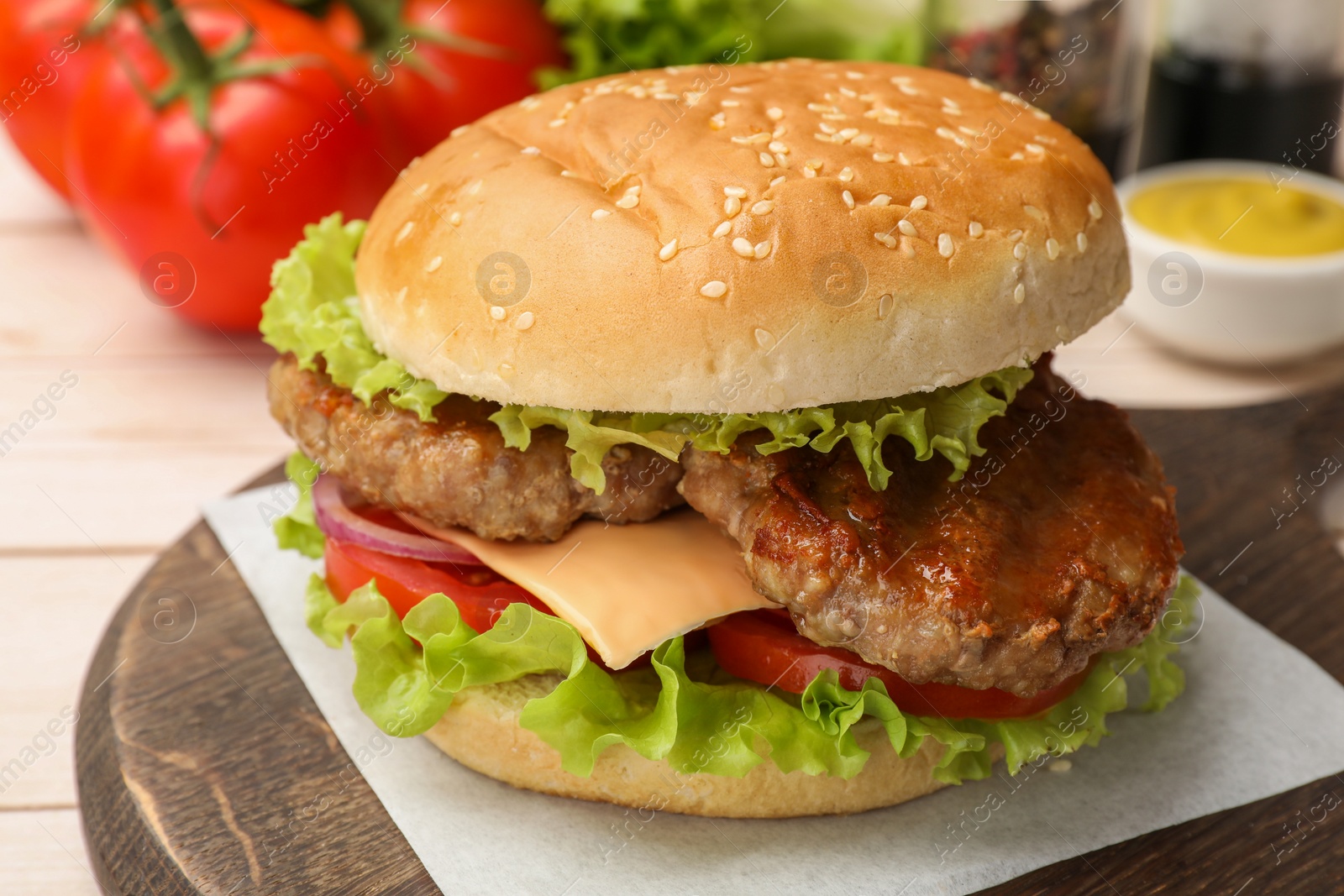 Photo of Tasty cheeseburger with patties, cheese and vegetables on white table, closeup
