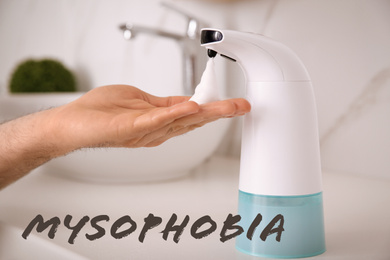 Image of Man using automatic soap dispenser indoors, closeup. Mysophobia