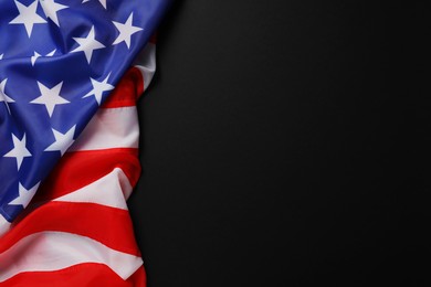 Photo of American flag on black background, top view with space for text