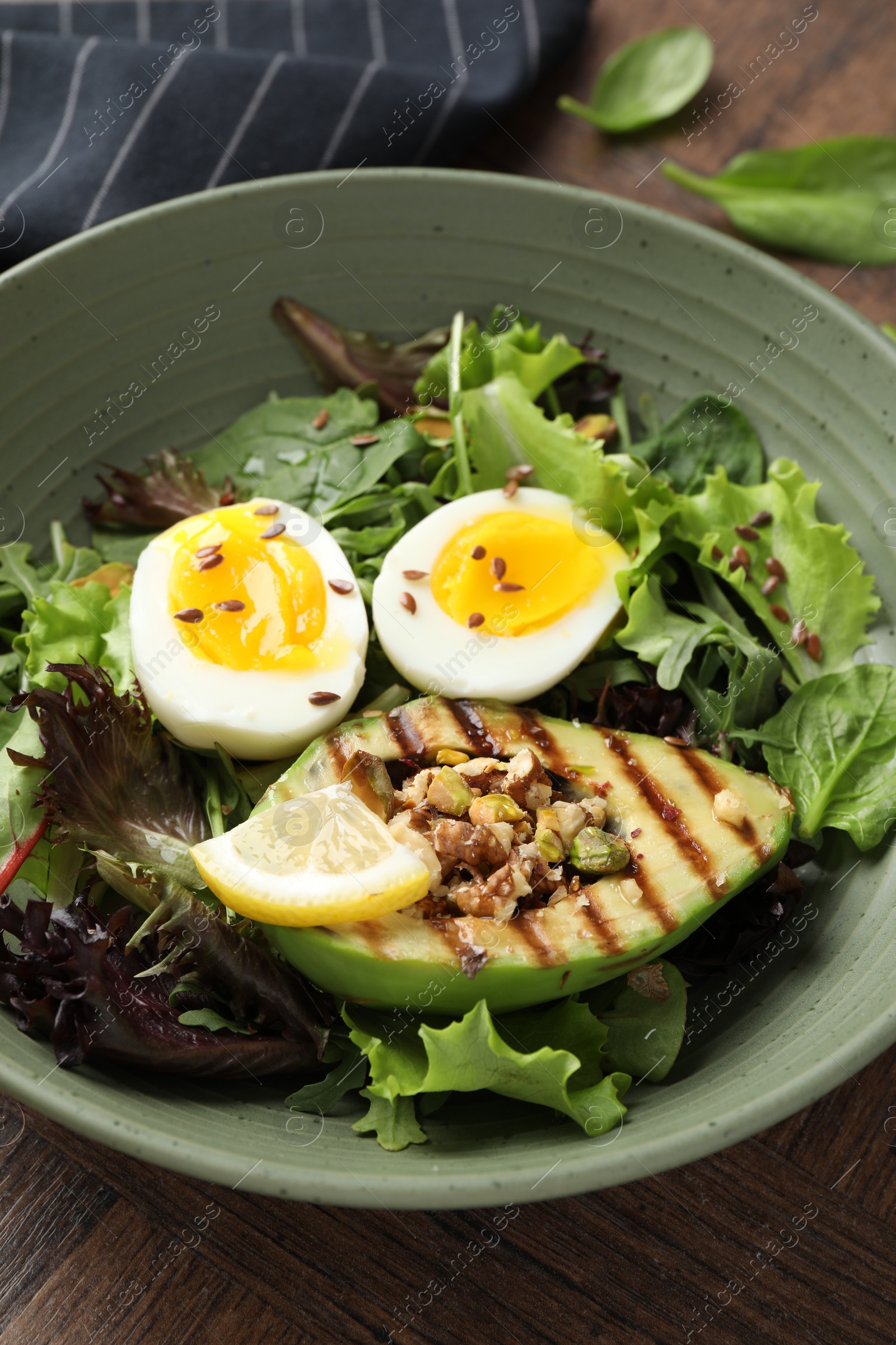 Photo of Healthy dish high in vegetable fats on wooden table, closeup