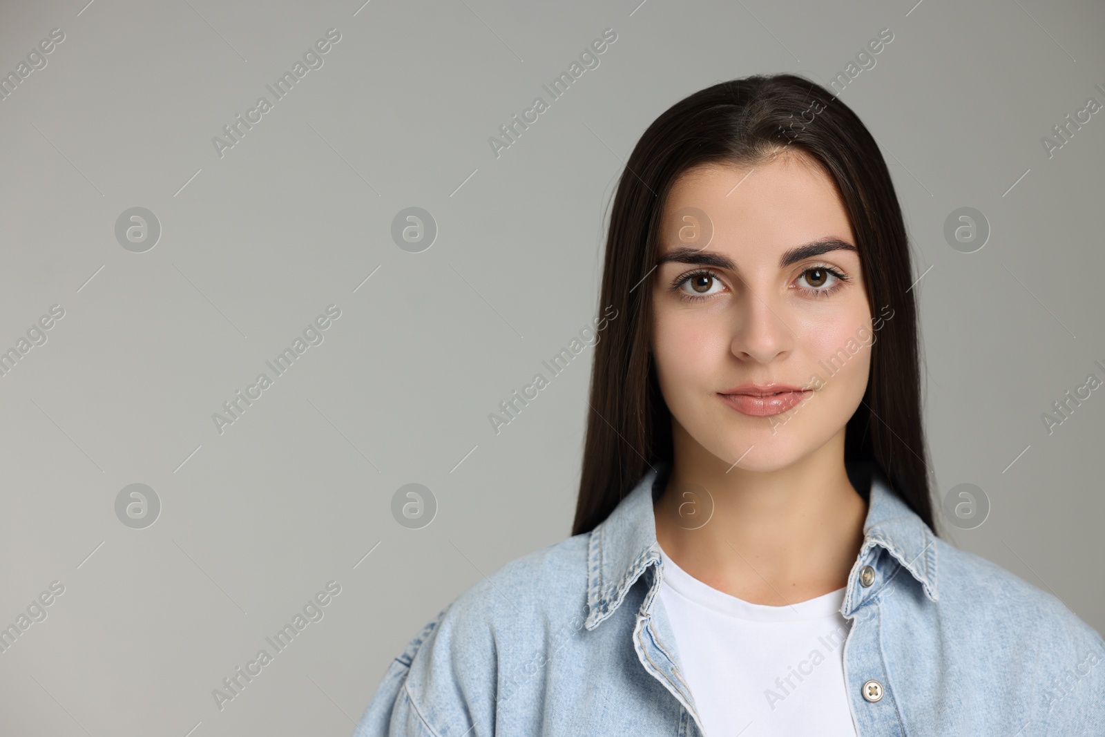 Photo of Portrait of beautiful woman on grey background. Space for text