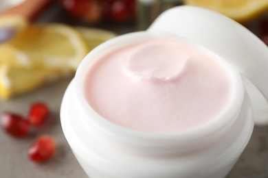 Photo of Natural pomegranate facial mask on table, closeup