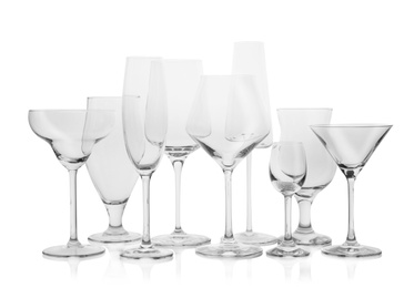 Set of empty glasses for different drinks on white background