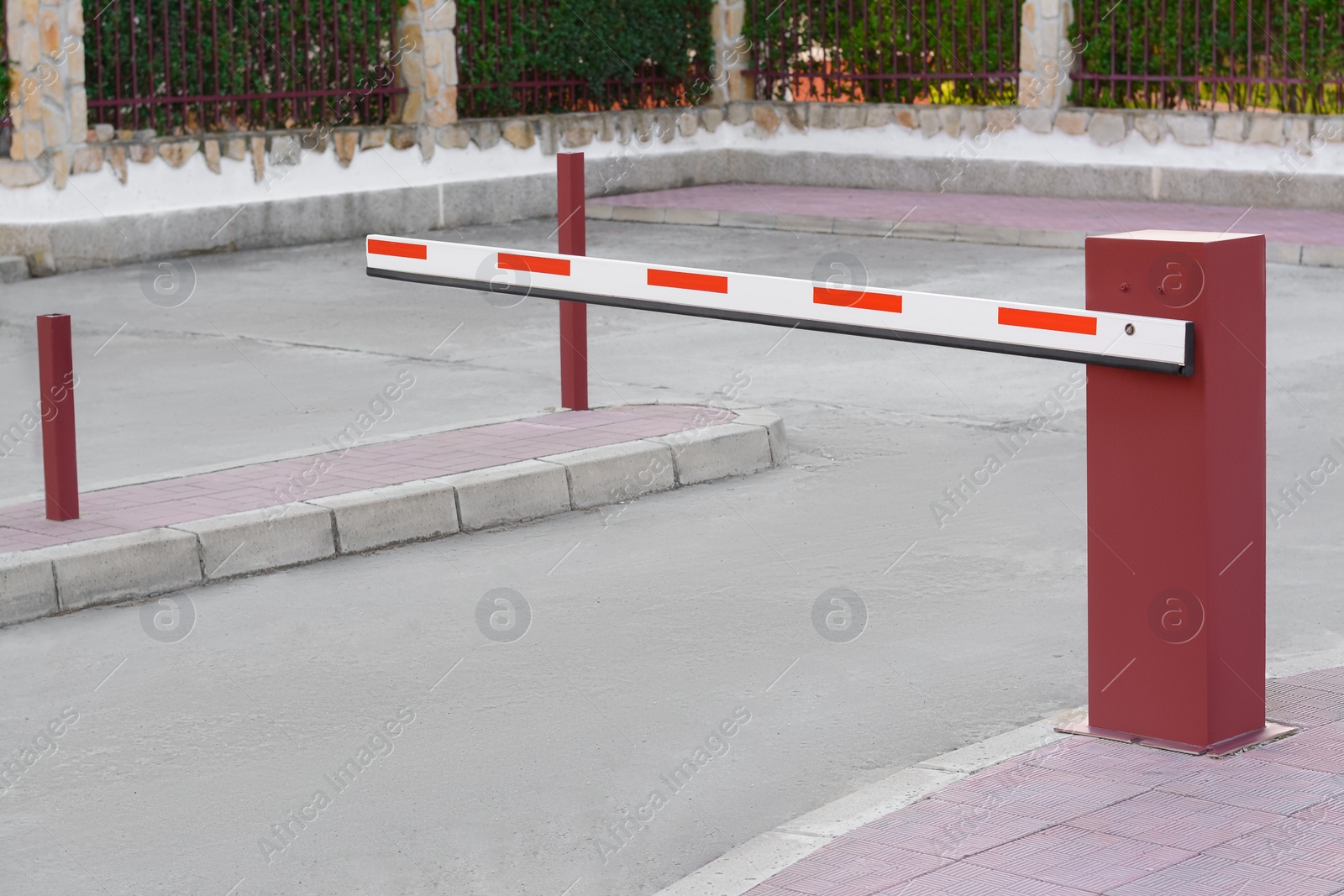 Photo of Closed boom barrier near road on autumn day outdoors