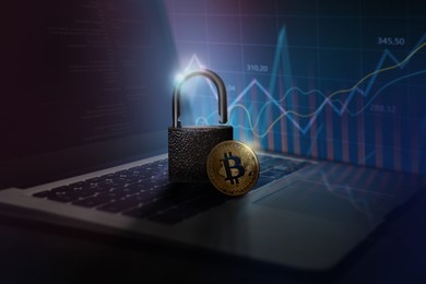 Digital currency security. Bitcoin and padlock on laptop. Charts and graphs