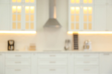 Blurred view of modern kitchen interior with stylish furniture