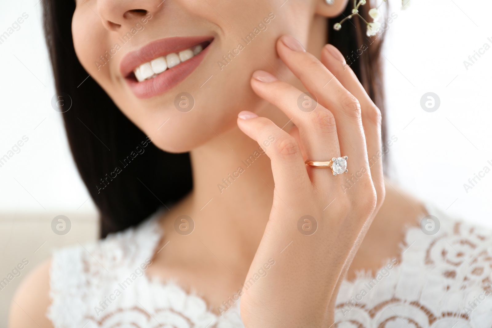 Photo of Young bride wearing beautiful engagement ring, closeup