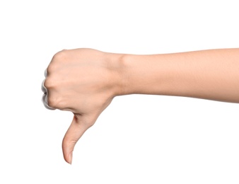 Woman showing thumb down sign on white background, closeup. Body language